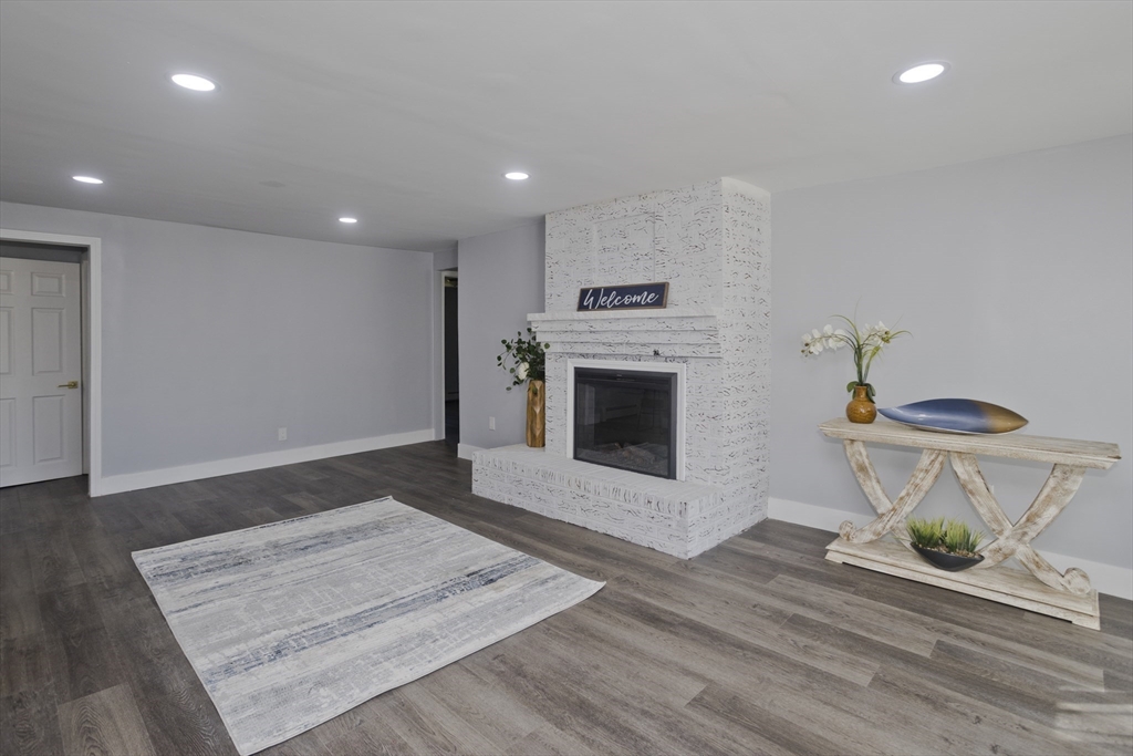 138 Stapleton Road Springfield, MA 01109 - Photo 3 of 38 a view of a kitchen with a sink a fireplace and wooden floor