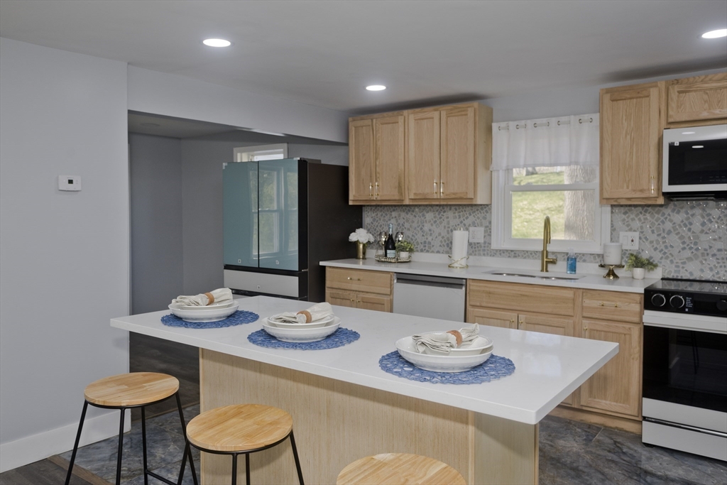 138 Stapleton Road Springfield, MA 01109 - Photo 9 of 38 a kitchen with a dining table and chairs