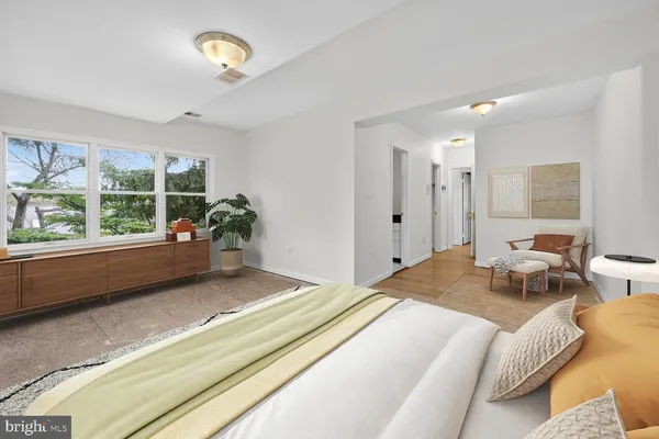 a bedroom with a bed window and couch