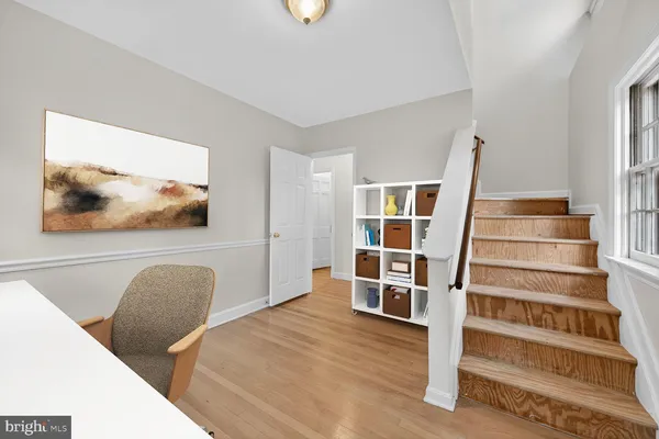 a view of bedroom with wooden floor and window