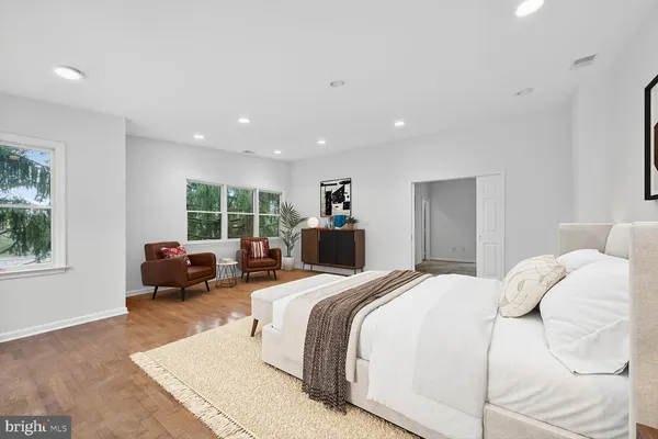 a bedroom with a bed and a large window