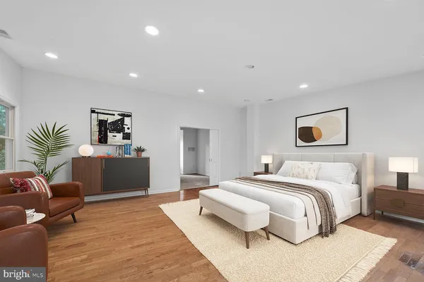 a spacious bedroom with a large bed and a couch