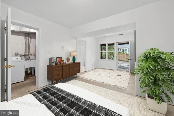 a large bedroom with a bed and a large window