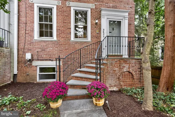 a front view of a house with an outdoor seating