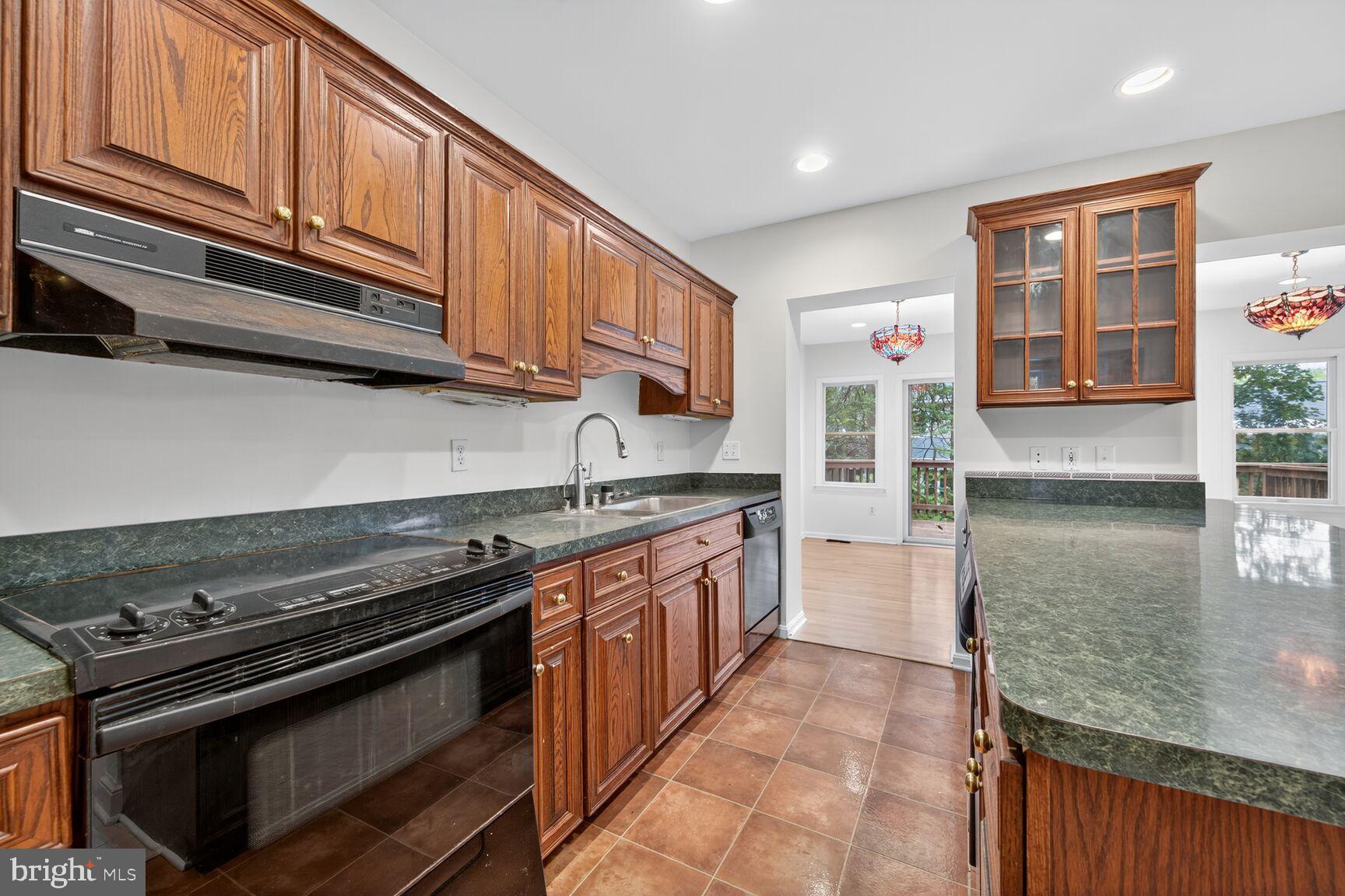 3625 Jenifer Street Northwest Washington, DC 20015 - Photo 6 of 30 Elegant kitchen with rich wood cabinetry.