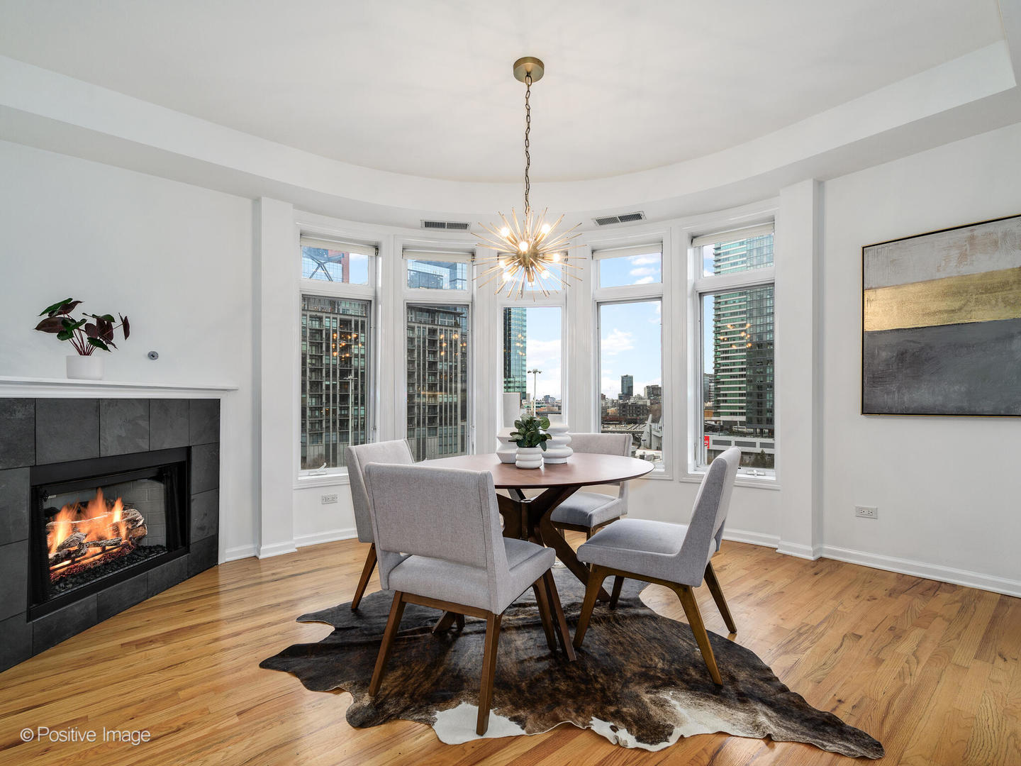 657 West Fulton Street, Unit 708 Chicago, IL 60661 - Photo 11 of 22 a dining room with furniture a fireplace and wooden floor