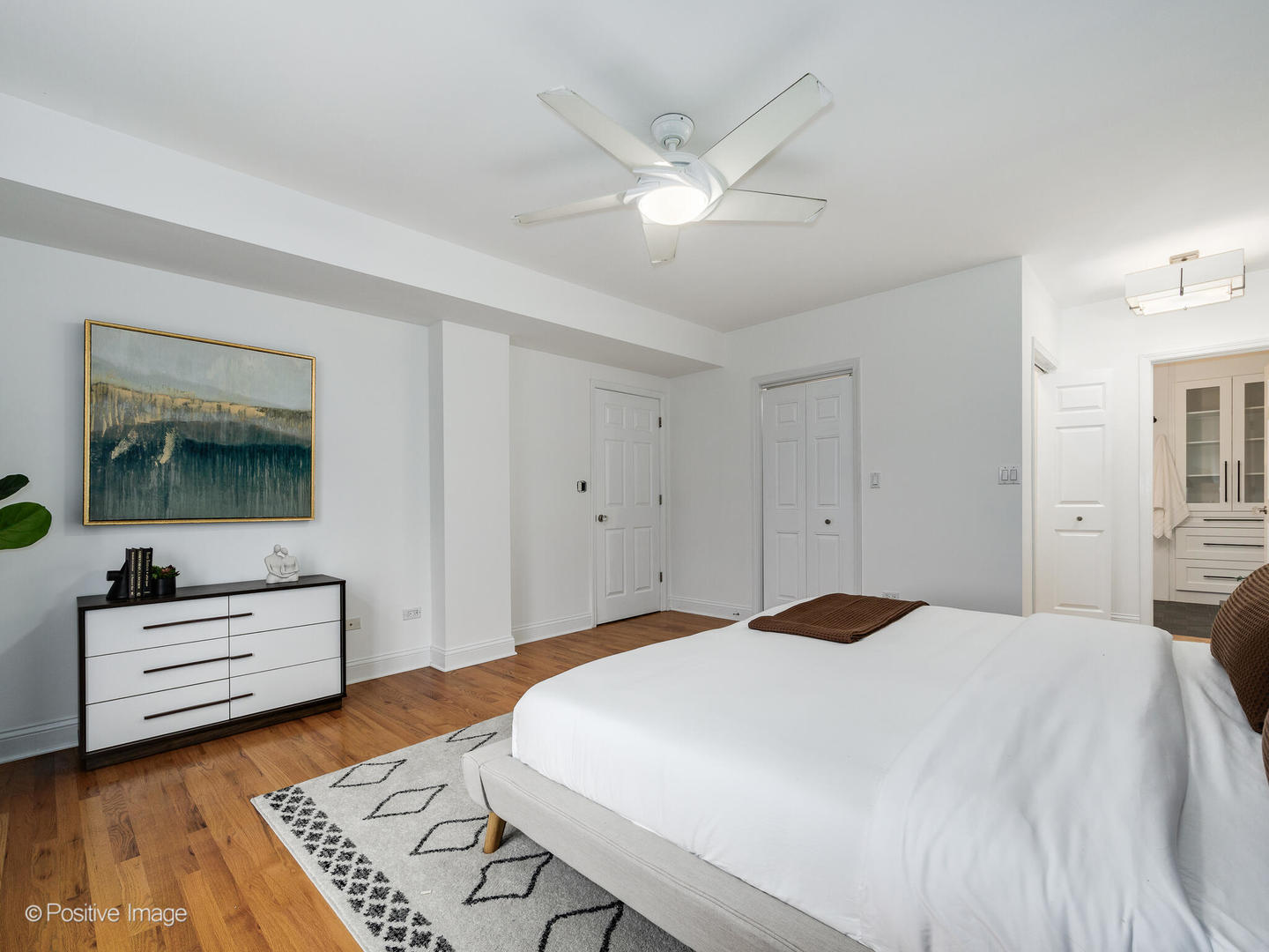 657 West Fulton Street, Unit 708 Chicago, IL 60661 - Photo 16 of 22 a bedroom with a bed and a chandelier