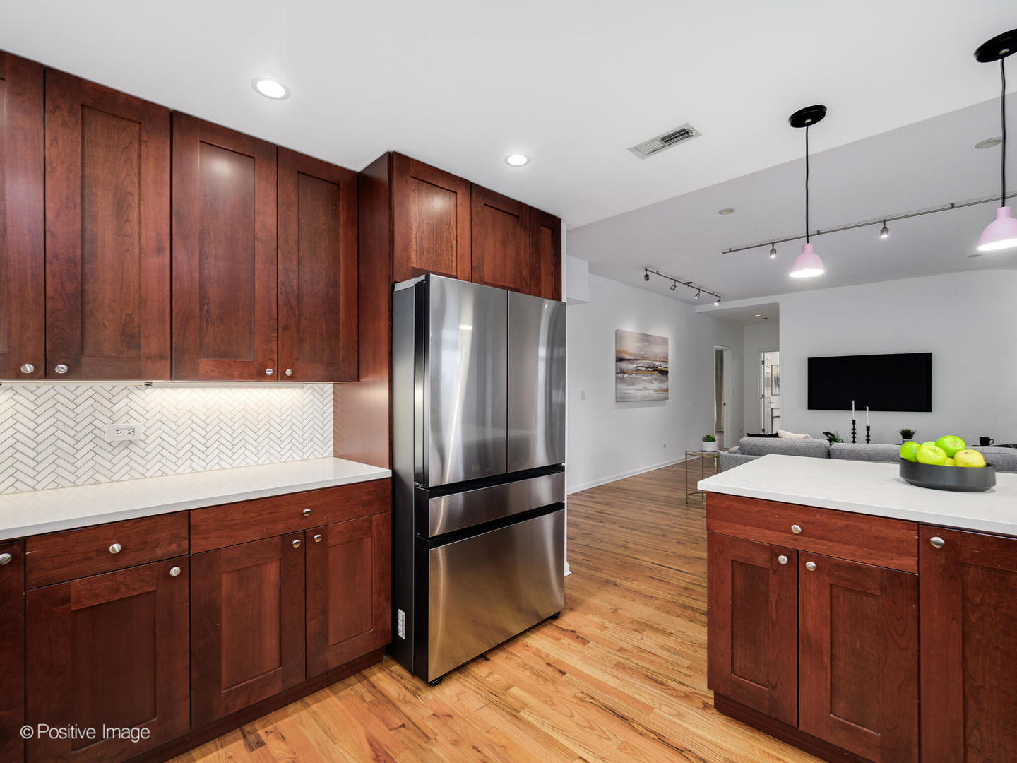657 West Fulton Street, Unit 708 Chicago, IL 60661 - Photo 5 of 22 a kitchen with wooden cabinets a refrigerator and a sink