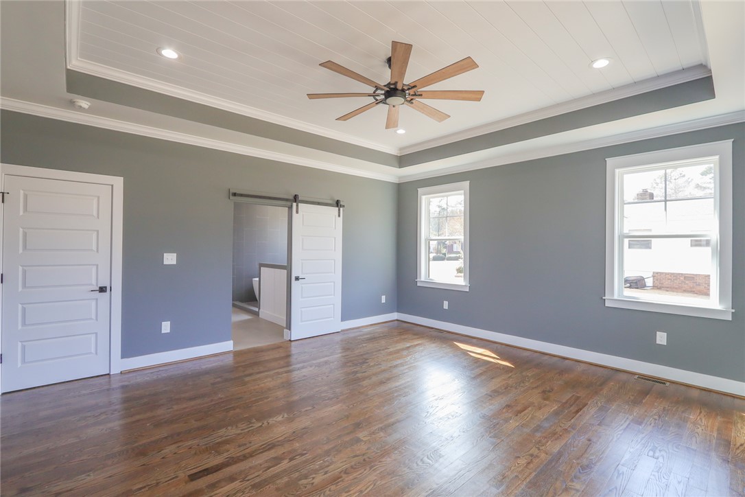 2403 Warriors Path Anderson, SC 29621 - Photo 18 of 50 This spacious bedroom features elegant hardwood floors and ample natural light, perfect for relaxation.