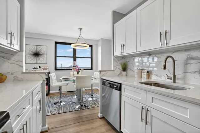 a kitchen with a sink cabinets and wooden floor