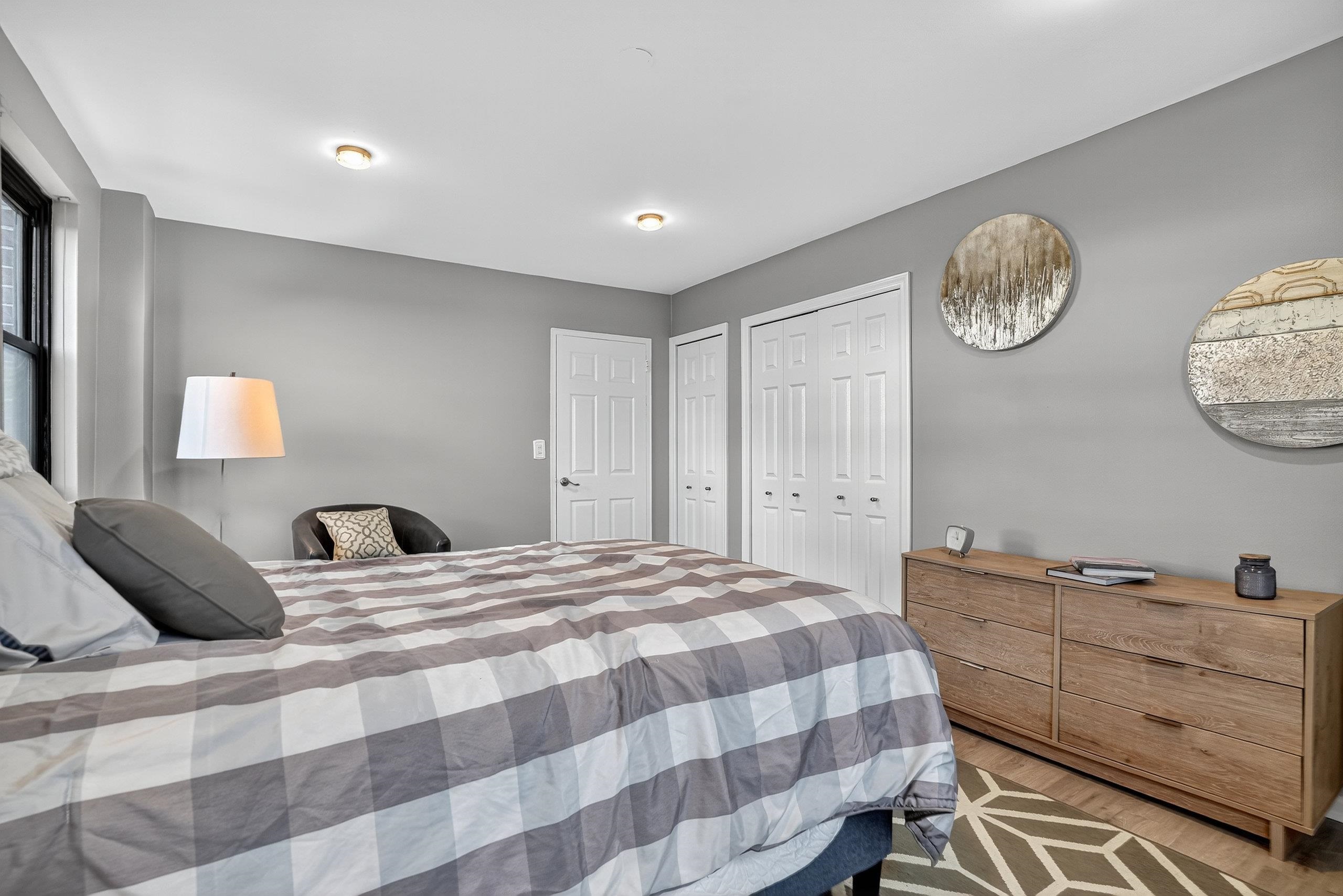 1225 John F. Kennedy Boulevard, Unit 12K Bayonne, NJ 07002 - Photo 14 of 18 a bedroom with a bed and closet