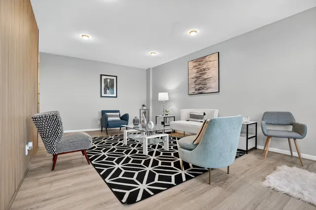 a living room with furniture a couch and wooden floor