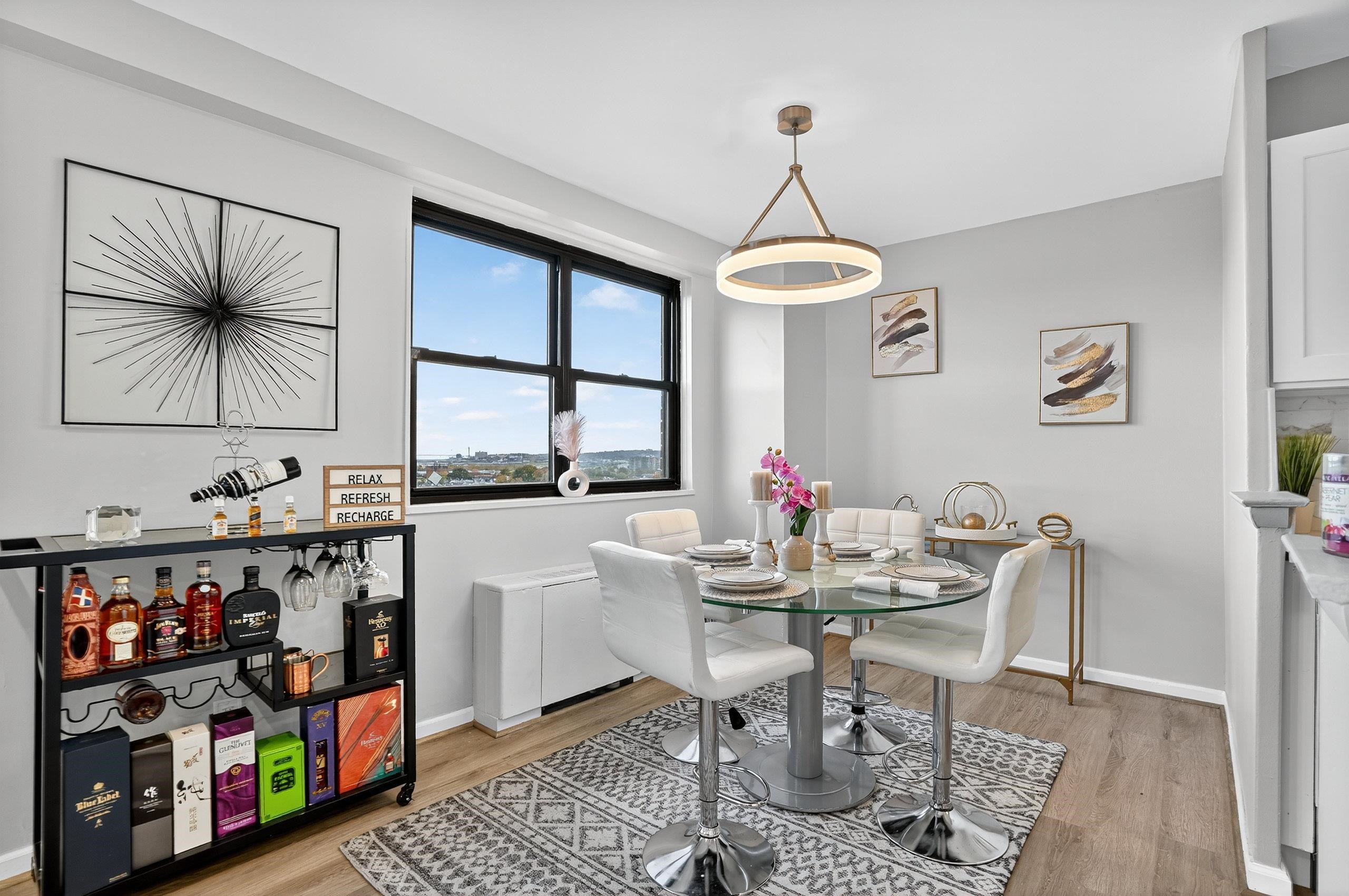 1225 John F. Kennedy Boulevard, Unit 12K Bayonne, NJ 07002 - Photo 8 of 18 a view of a dining room with furniture window and outside view