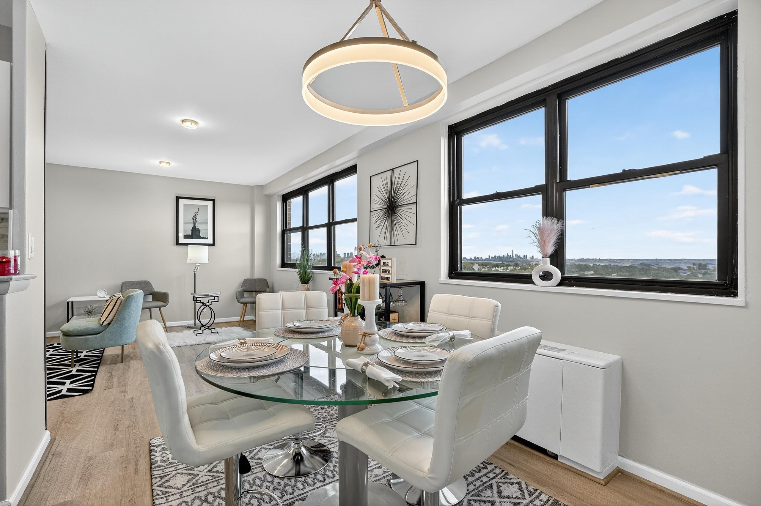 1225 John F. Kennedy Boulevard, Unit 12K Bayonne, NJ 07002 - Photo 9 of 18 a view of a dining room with furniture wooden floor and a chandelier