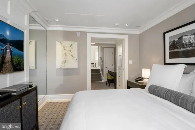 a bedroom with a bed and a night stand