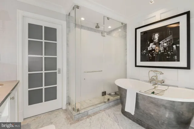 a kitchen with white cabinets and refrigerator