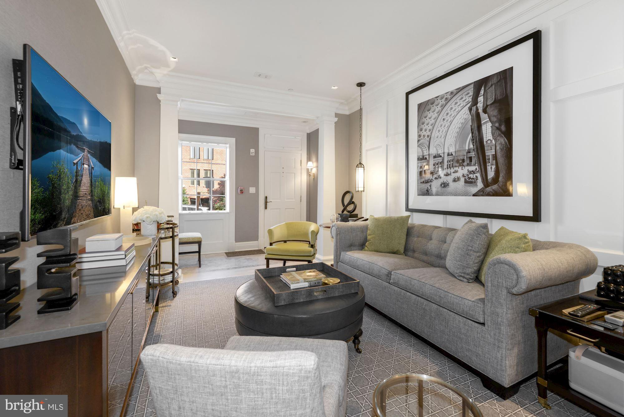 1026 31st Street Northwest Washington, DC 20007 - Photo 3 of 59 a living room with furniture and a flat screen tv