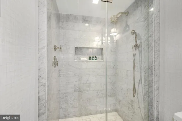 a spacious bathroom with double vanity and a shower