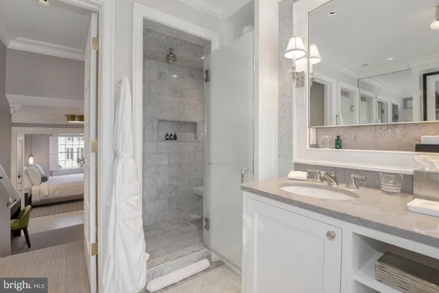 a bathroom with a granite countertop sink a large mirror and a toilet