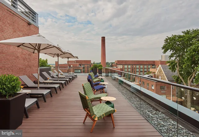 a living room with lots of furniture and a floor to ceiling window