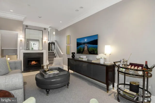 a living room with a couch a flat screen tv and a fireplace