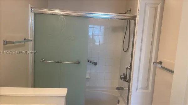 a bathroom with a glass shower door