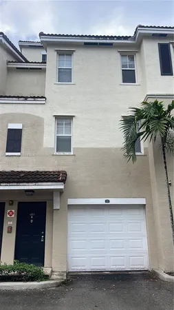 a front view of a house with a garage