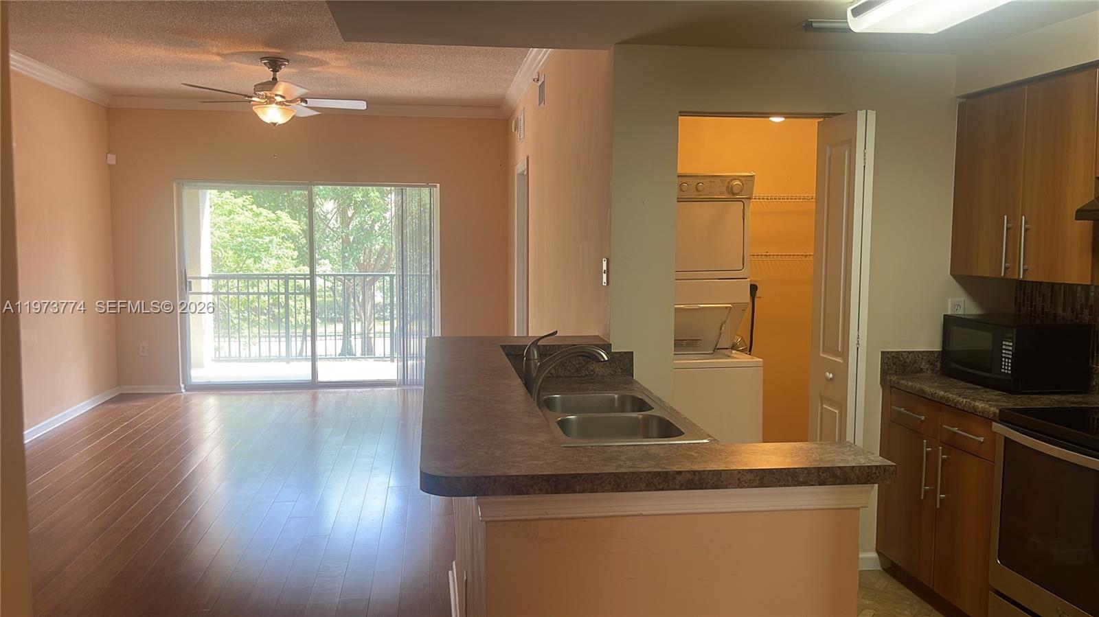 6020 West Sample Road, Unit 207 Coral Springs, FL 33067 - Photo 8 of 17 a kitchen with sink and window