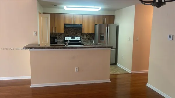 a view of a kitchen with wooden floor