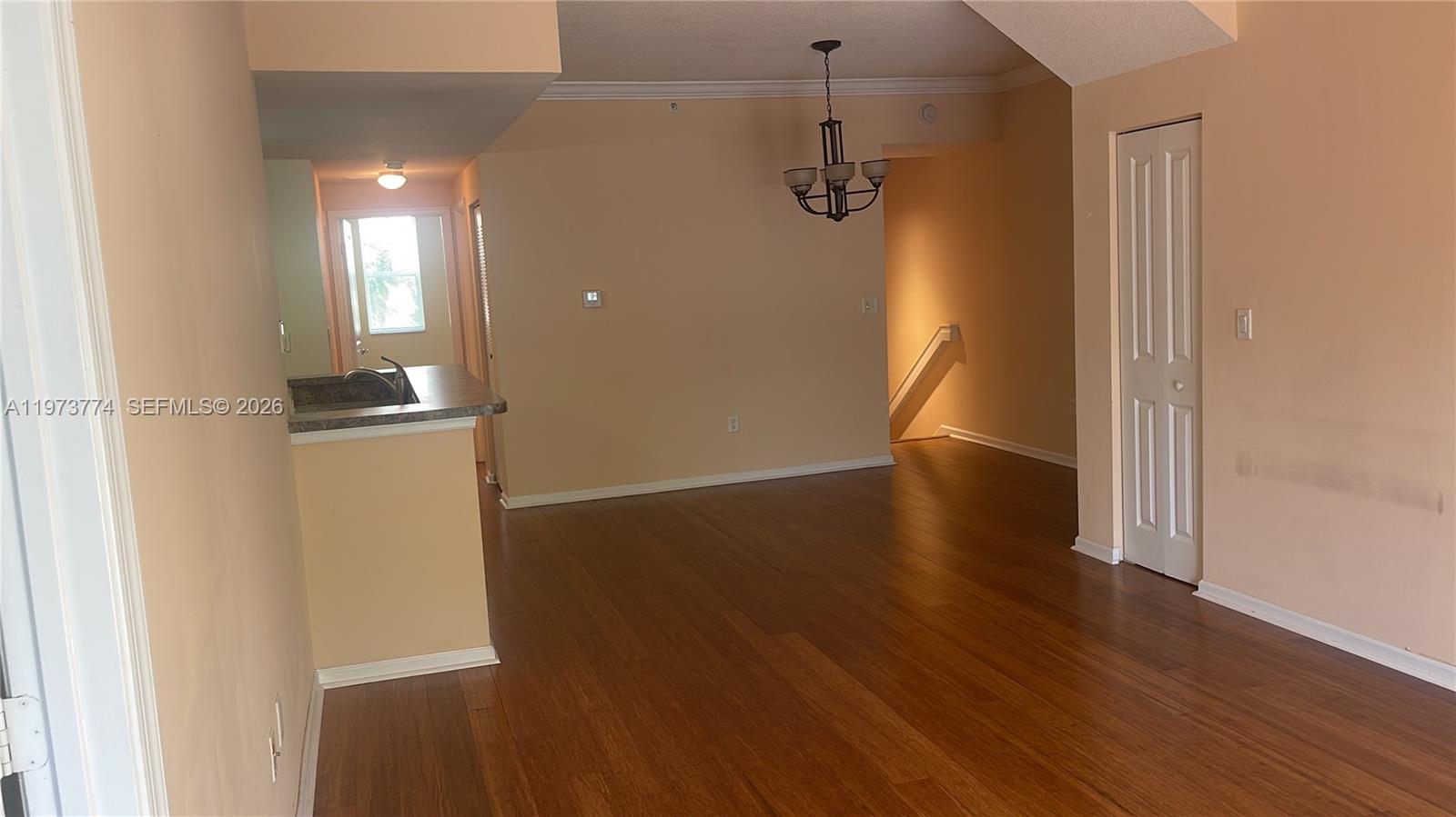 6020 West Sample Road, Unit 207 Coral Springs, FL 33067 - Photo 10 of 17 an empty room with wooden floor and windows