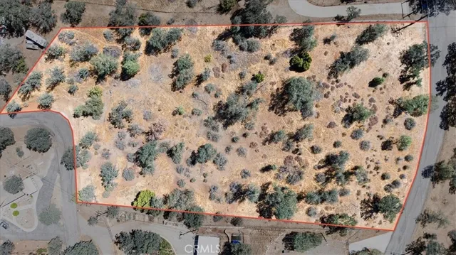 a view of a dry yard with mountains in the background