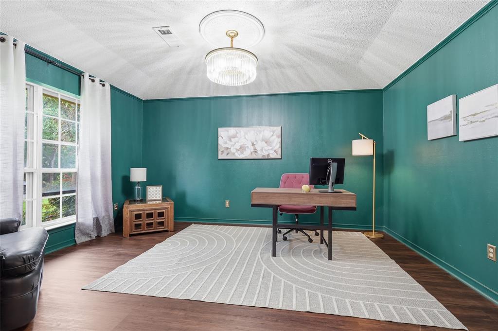 823 Ridgecrest Circle Denton, TX 76205 - Photo 6 of 40 Spacious interior with rich teal walls and wood-finish flooring