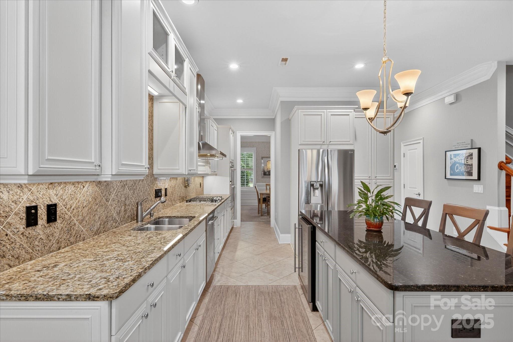 9614 Wheatfield Road Charlotte, NC 28277 - Photo 15 of 47 a kitchen with stainless steel appliances granite countertop a sink a stove top oven a counter space and cabinets