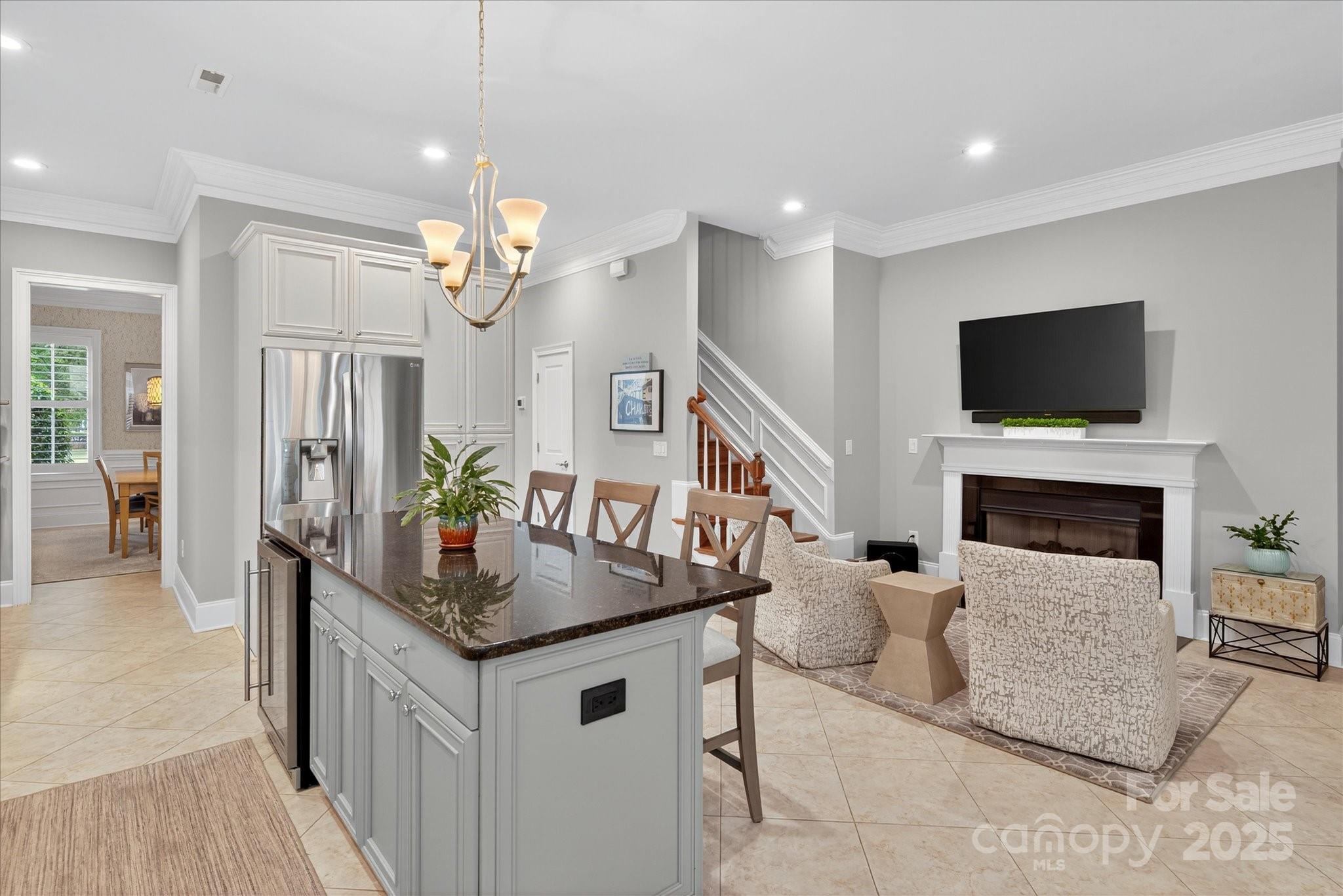 9614 Wheatfield Road Charlotte, NC 28277 - Photo 16 of 47 a kitchen with granite countertop a sink a counter top space stainless steel appliances a chandelier and living room view