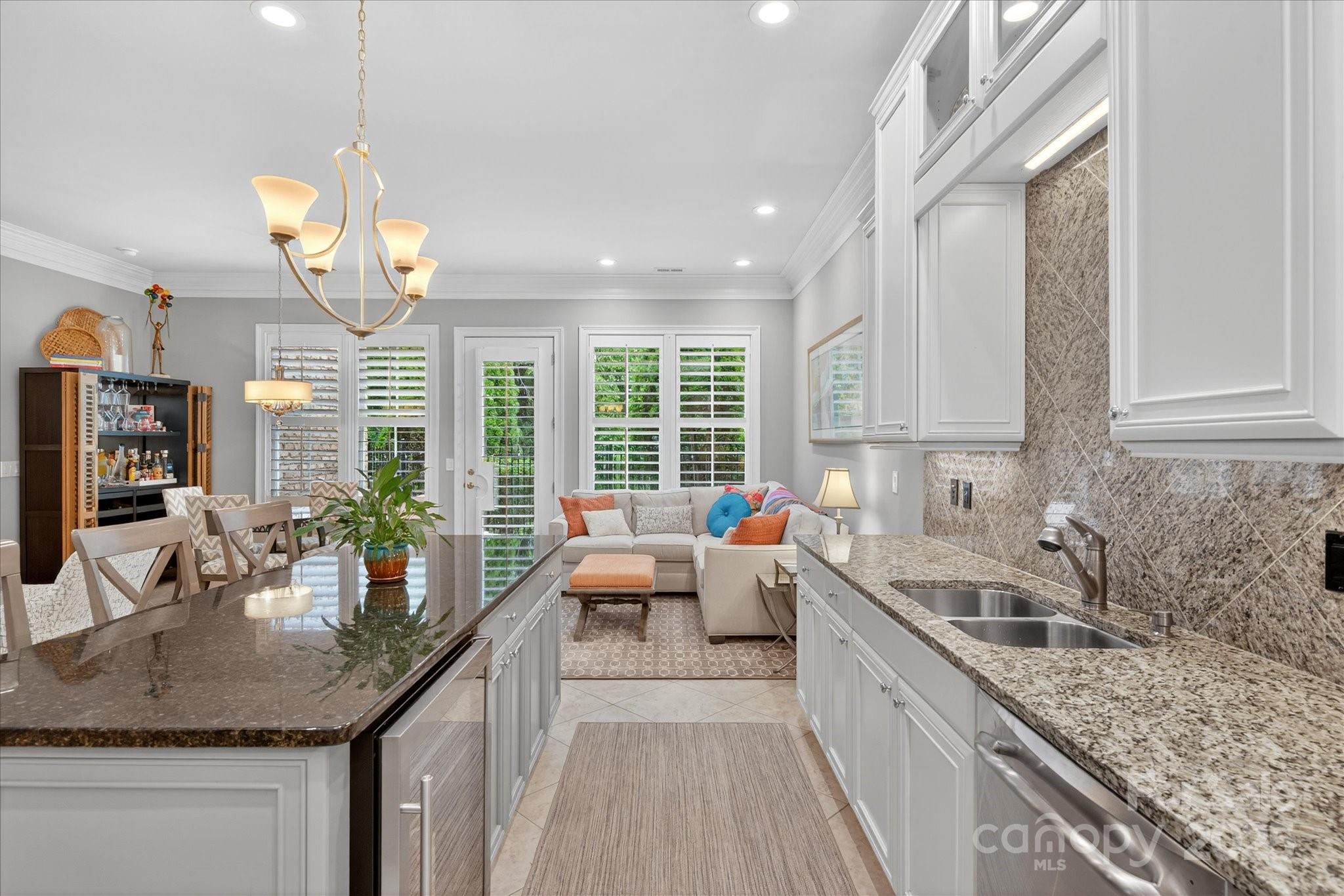 9614 Wheatfield Road Charlotte, NC 28277 - Photo 17 of 47 a kitchen with granite countertop a sink large counter stainless steel appliances and cabinets