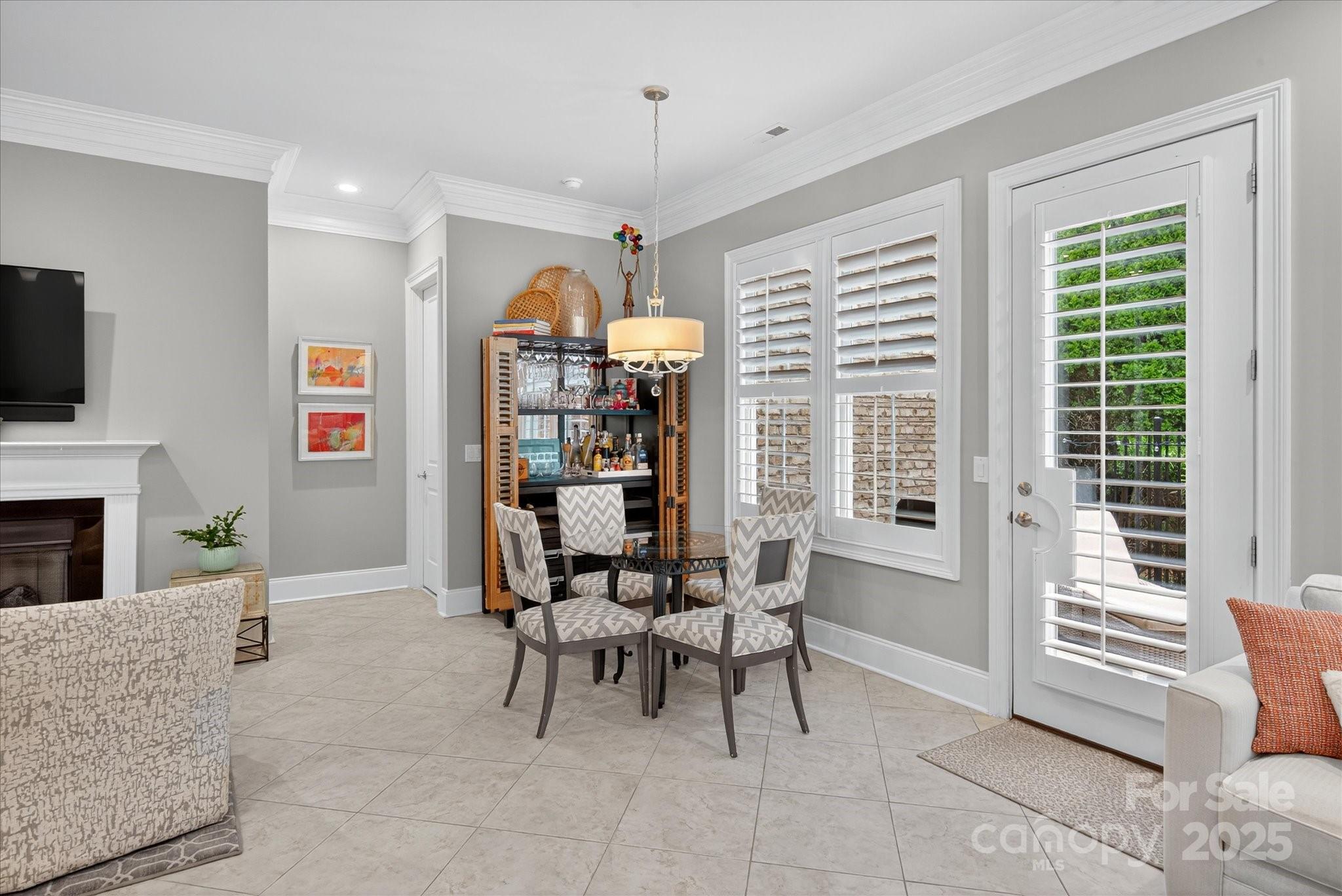 9614 Wheatfield Road Charlotte, NC 28277 - Photo 19 of 47 a living room with furniture a fireplace and a flat screen tv