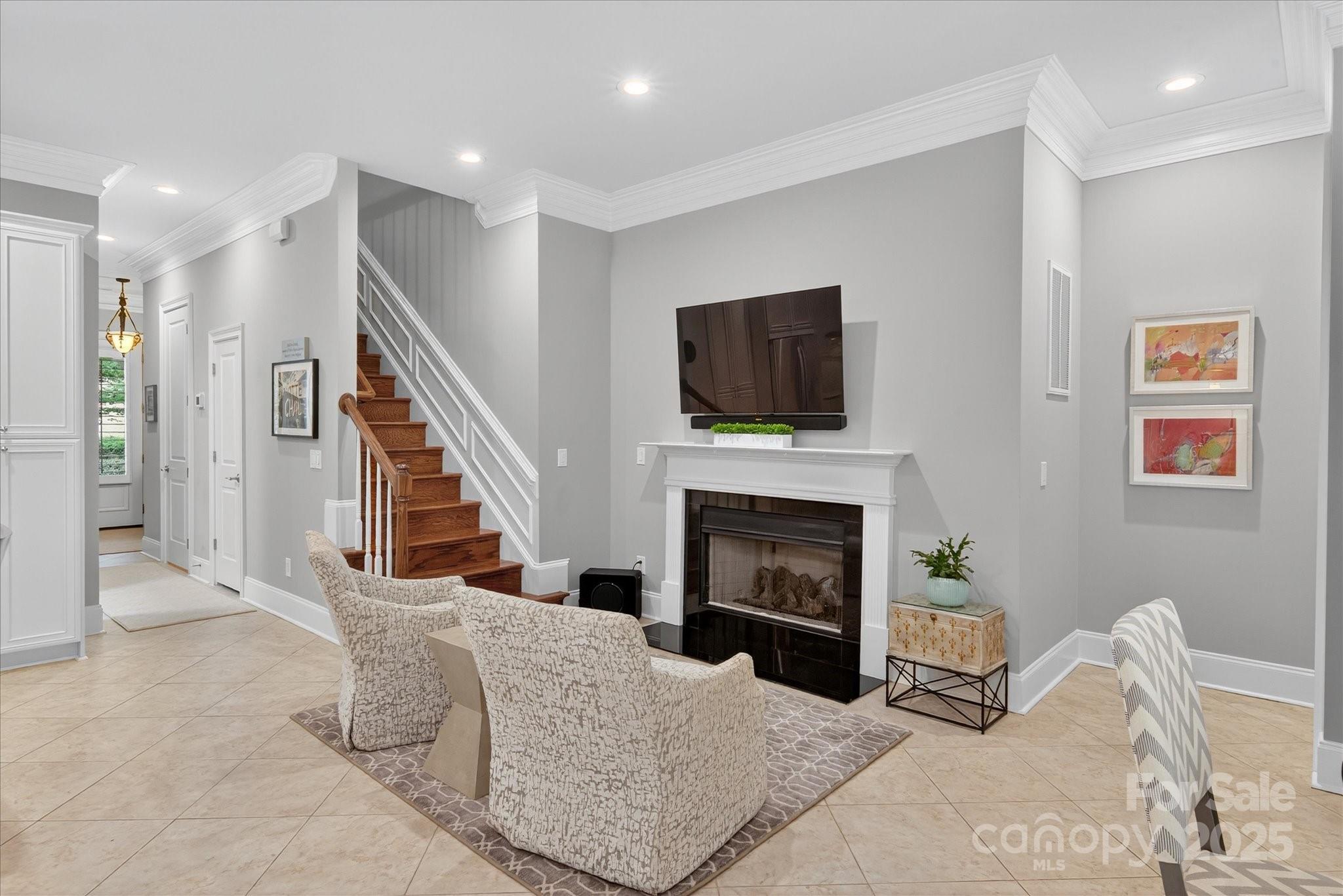 9614 Wheatfield Road Charlotte, NC 28277 - Photo 20 of 47 a living room with furniture a flat screen tv and a fireplace