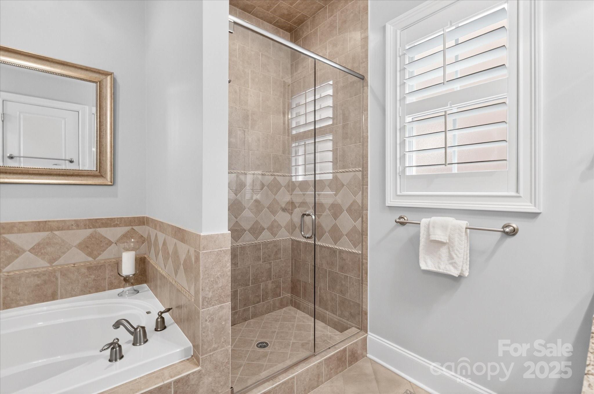 9614 Wheatfield Road Charlotte, NC 28277 - Photo 26 of 47 a bathroom with a bathtub and next to a window