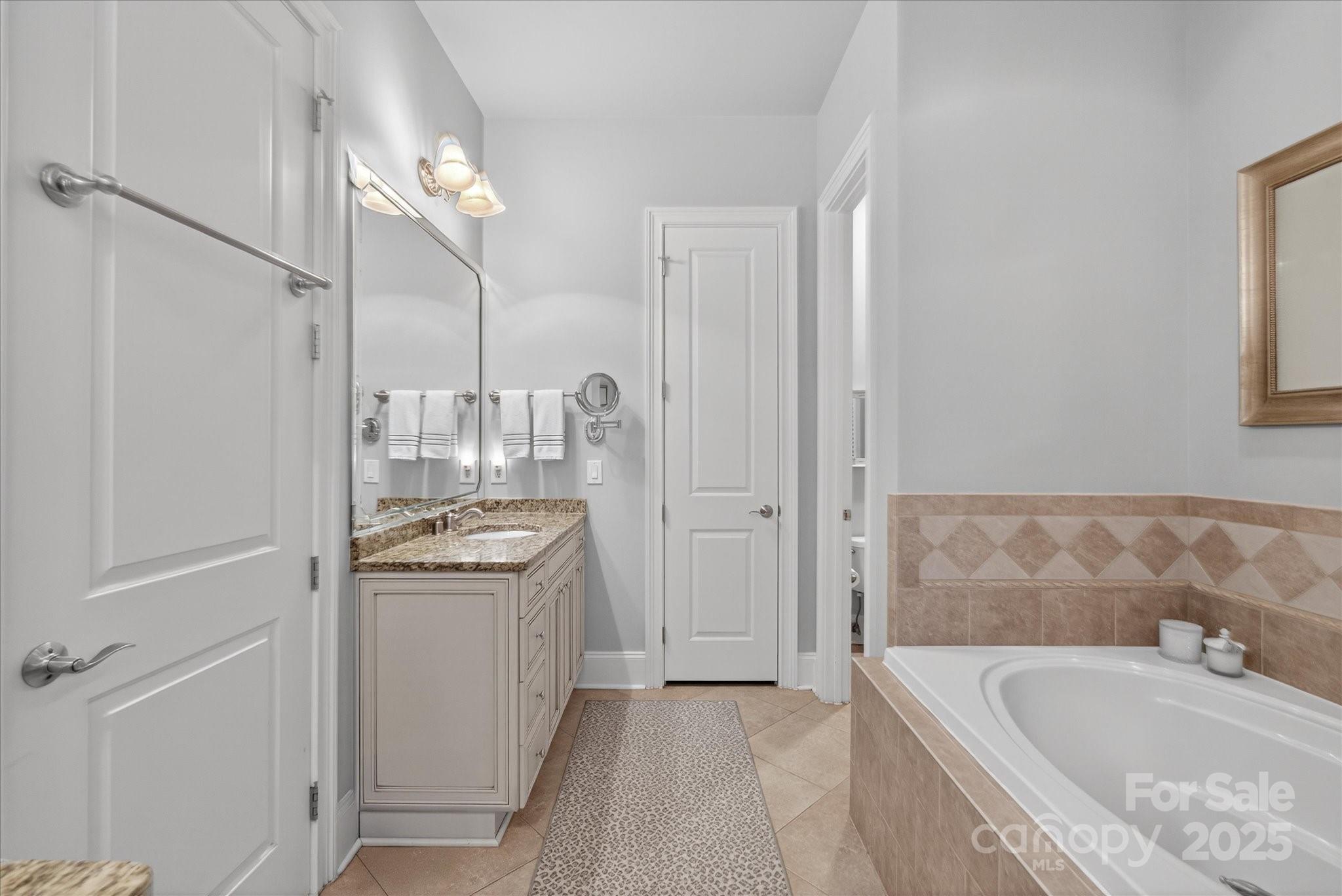 9614 Wheatfield Road Charlotte, NC 28277 - Photo 27 of 47 a bathroom with a granite countertop tub sink and mirror