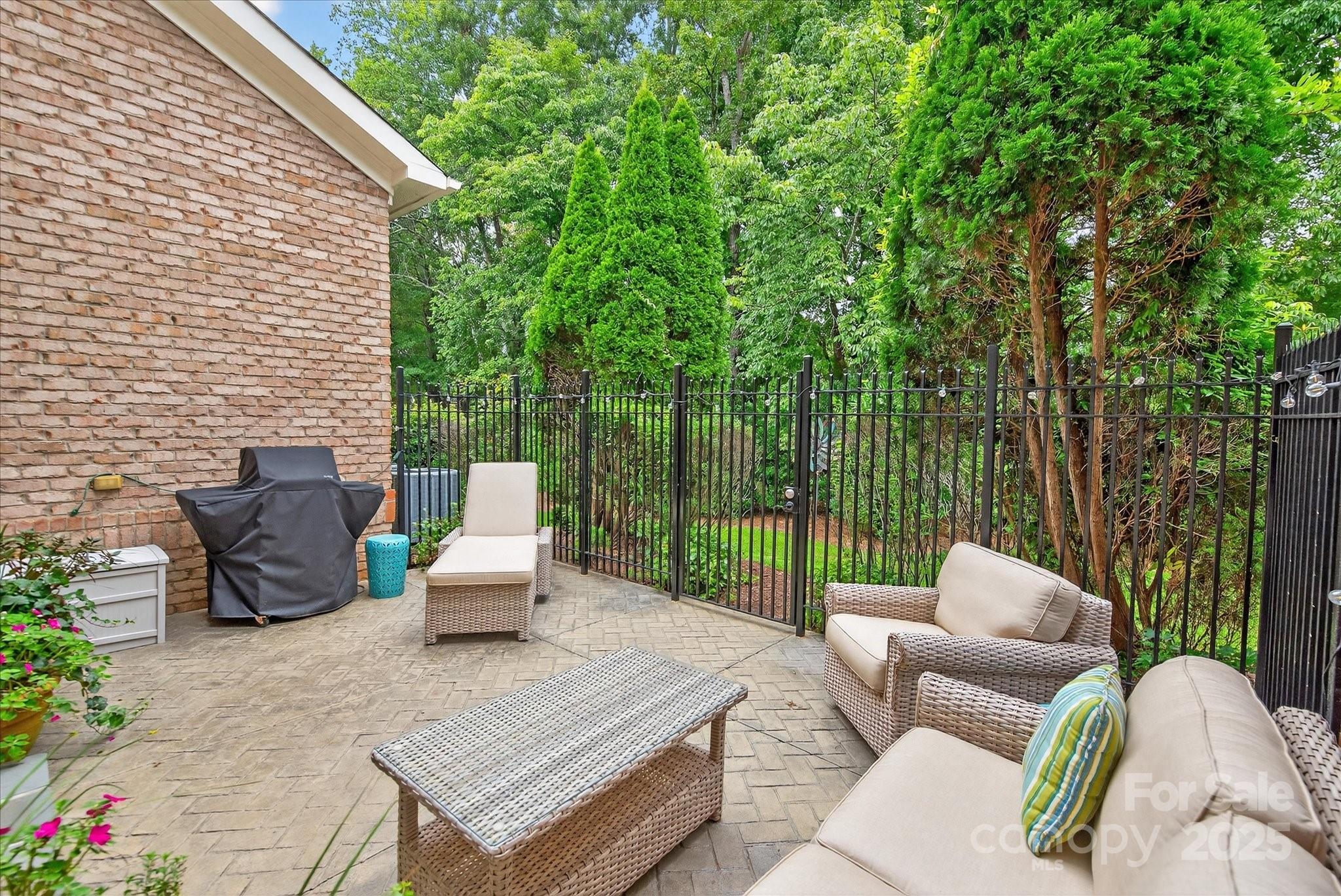 9614 Wheatfield Road Charlotte, NC 28277 - Photo 39 of 47 a view of a patio with couches chairs and a floor to ceiling window