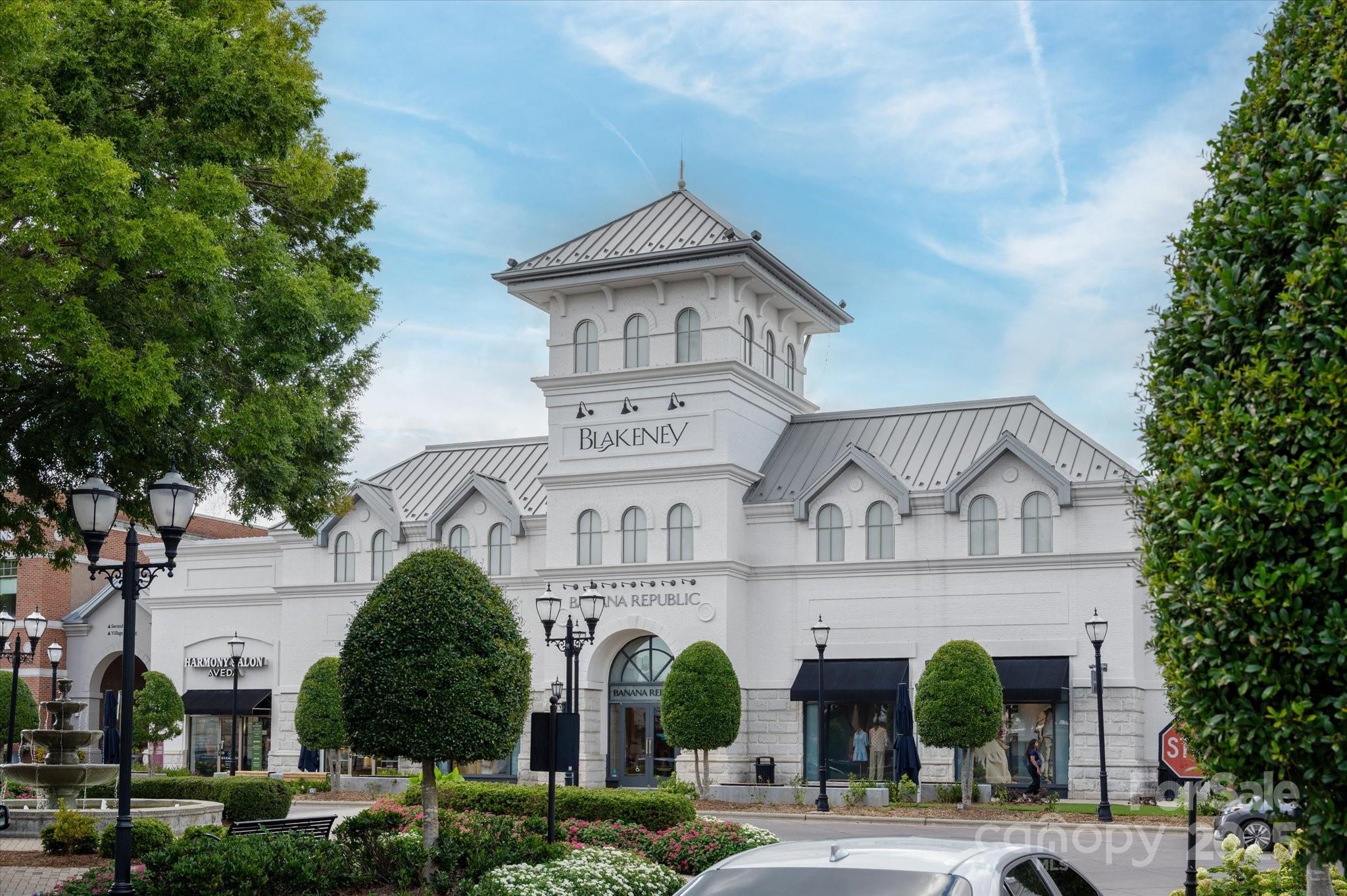 9614 Wheatfield Road Charlotte, NC 28277 - Photo 43 of 47 a view of a white building among the street and palm trees