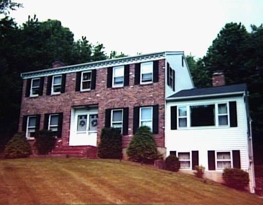 21 Ridge Road Newtown, CT 06470 - Photo 1 of 1 a view of a brick house with many windows next to a yard