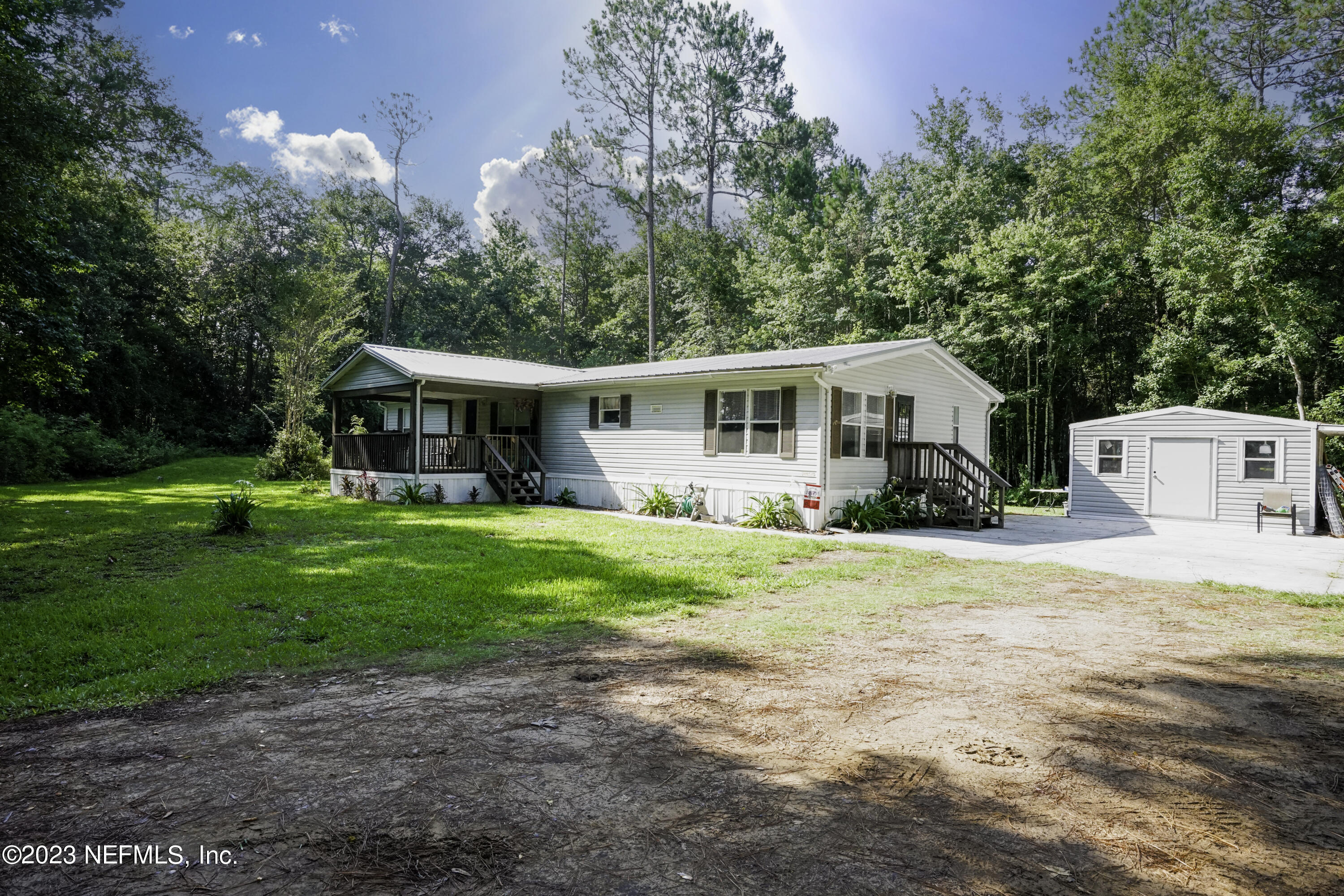 54593 Marsh Road Callahan, FL 32011 - Photo 1 of 14 a view of a house with a yard and sitting area
