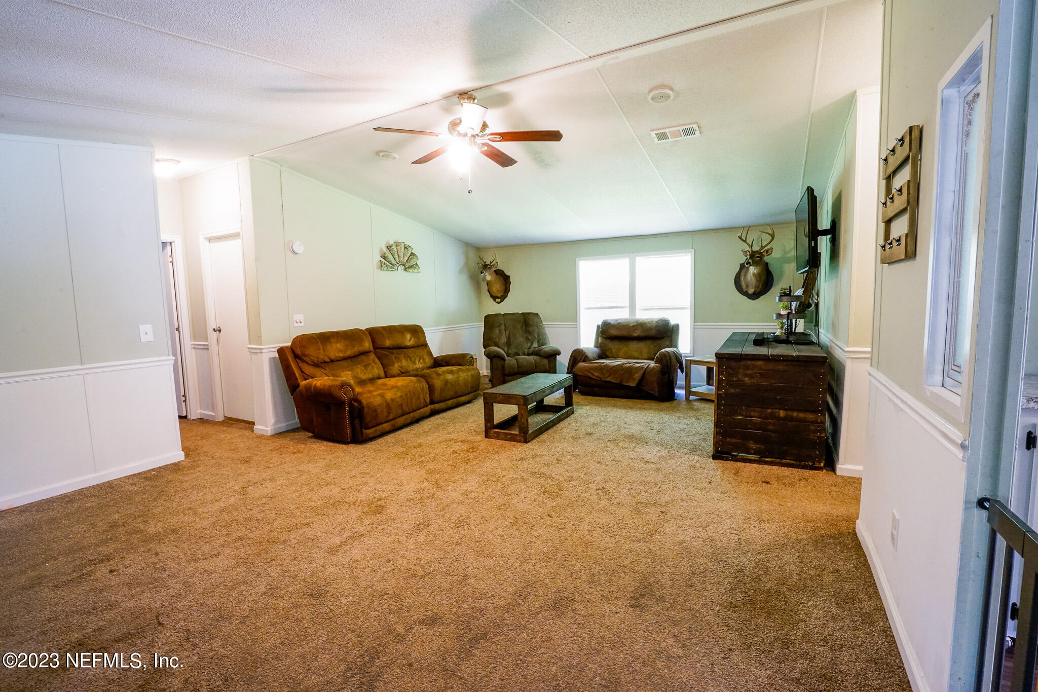 54593 Marsh Road Callahan, FL 32011 - Photo 6 of 14 a living room with furniture and a chandelier