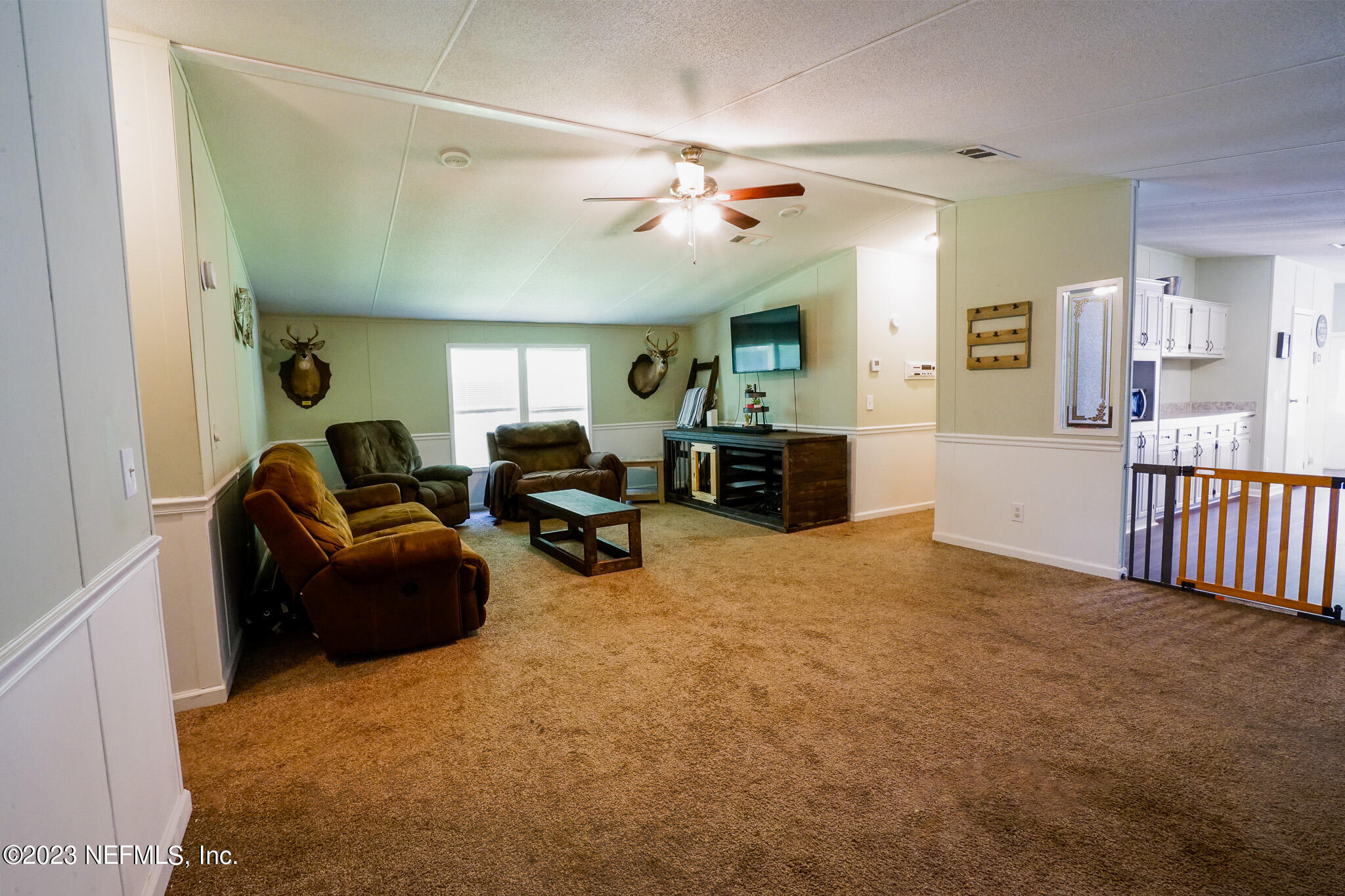 54593 Marsh Road Callahan, FL 32011 - Photo 7 of 14 a living room with furniture and a chandelier