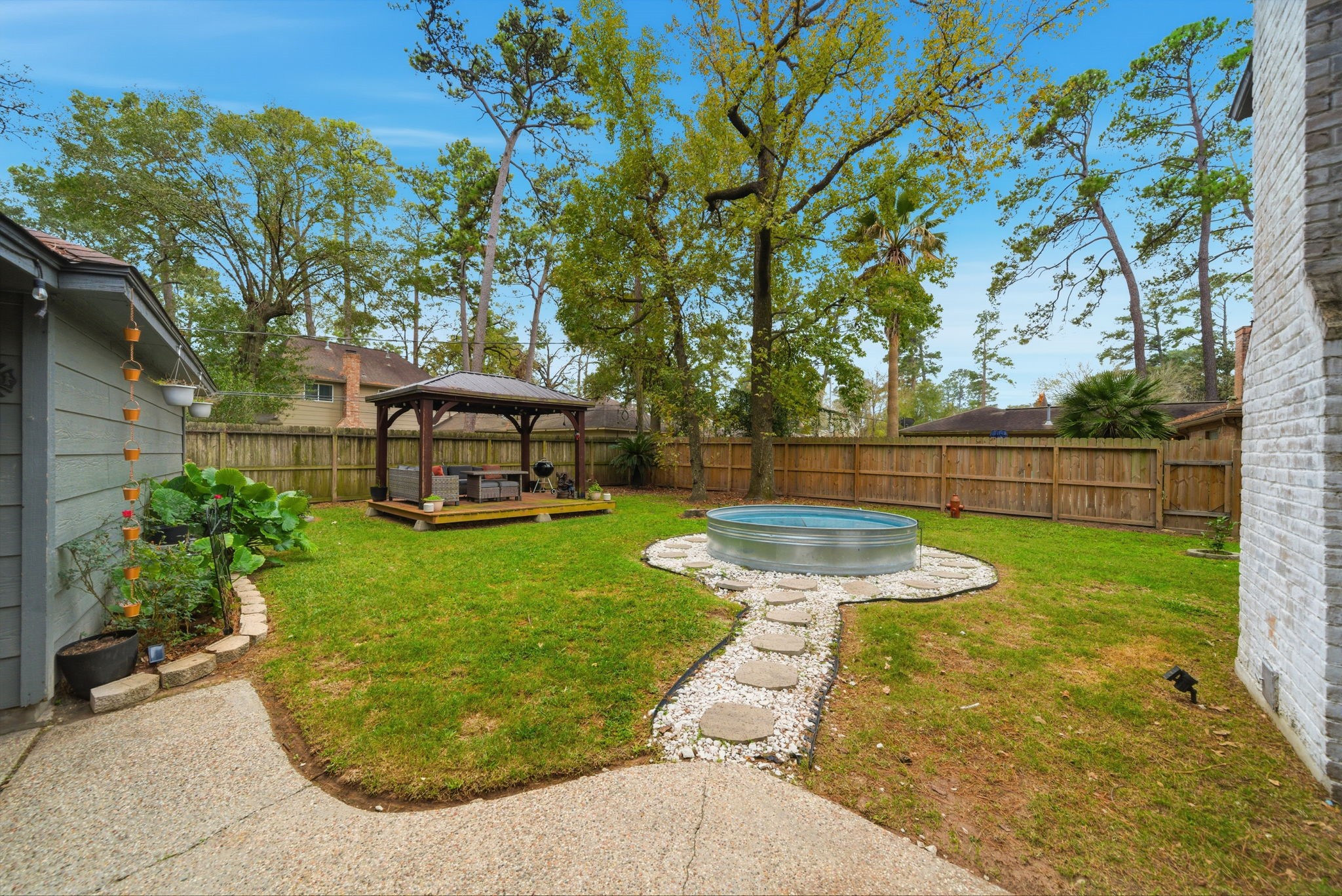 3315 Candleridge Drive Spring, TX 77388 - Photo 12 of 25 Discover backyard bliss with a charming stock pond pool, nestled amidst lush greenery and a cozy gazebo, perfect for relaxation and outdoor gatherings.