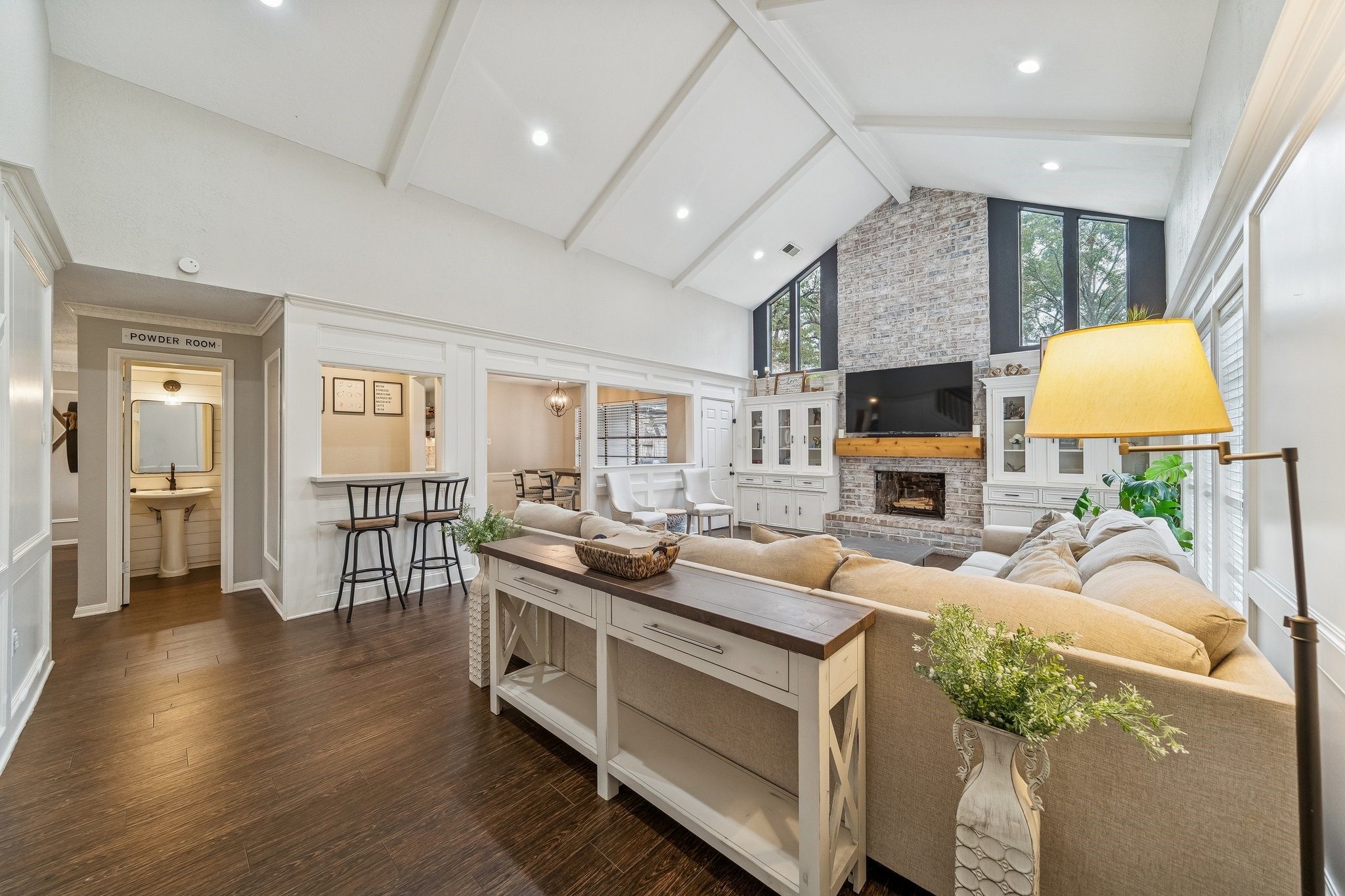 3315 Candleridge Drive Spring, TX 77388 - Photo 3 of 25 Discover the den's inviting elegance, where built-in shelves and soaring vaulted ceilings create an elevated, spacious retreat.