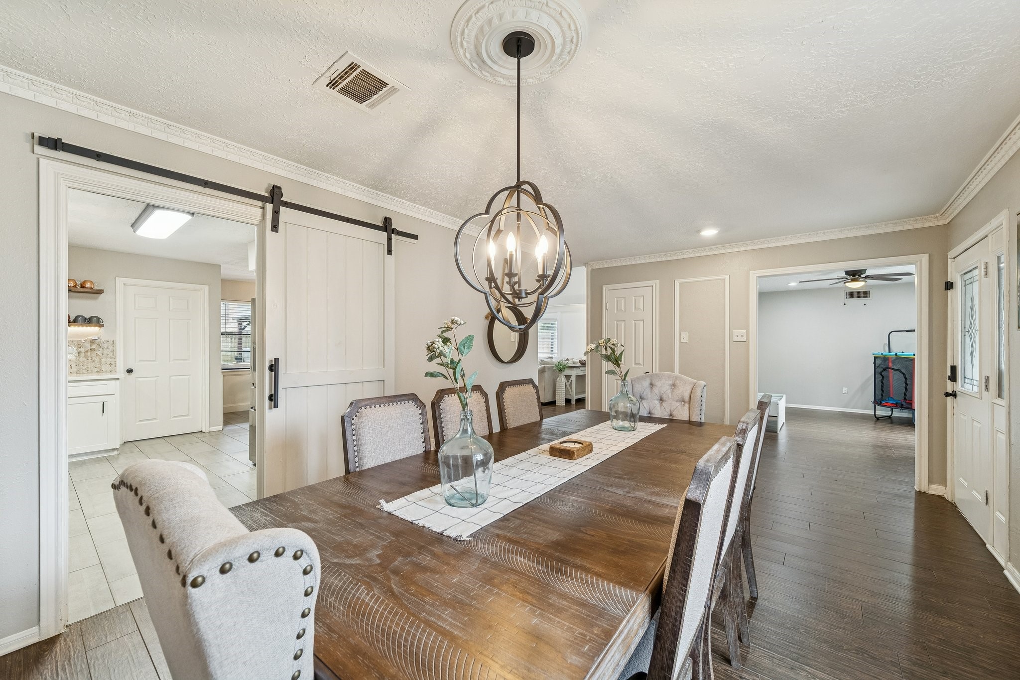 3315 Candleridge Drive Spring, TX 77388 - Photo 4 of 25 Experience elegant dining in this spacious formal room, enhanced by charming barn doors for a rustic yet sophisticated touch.