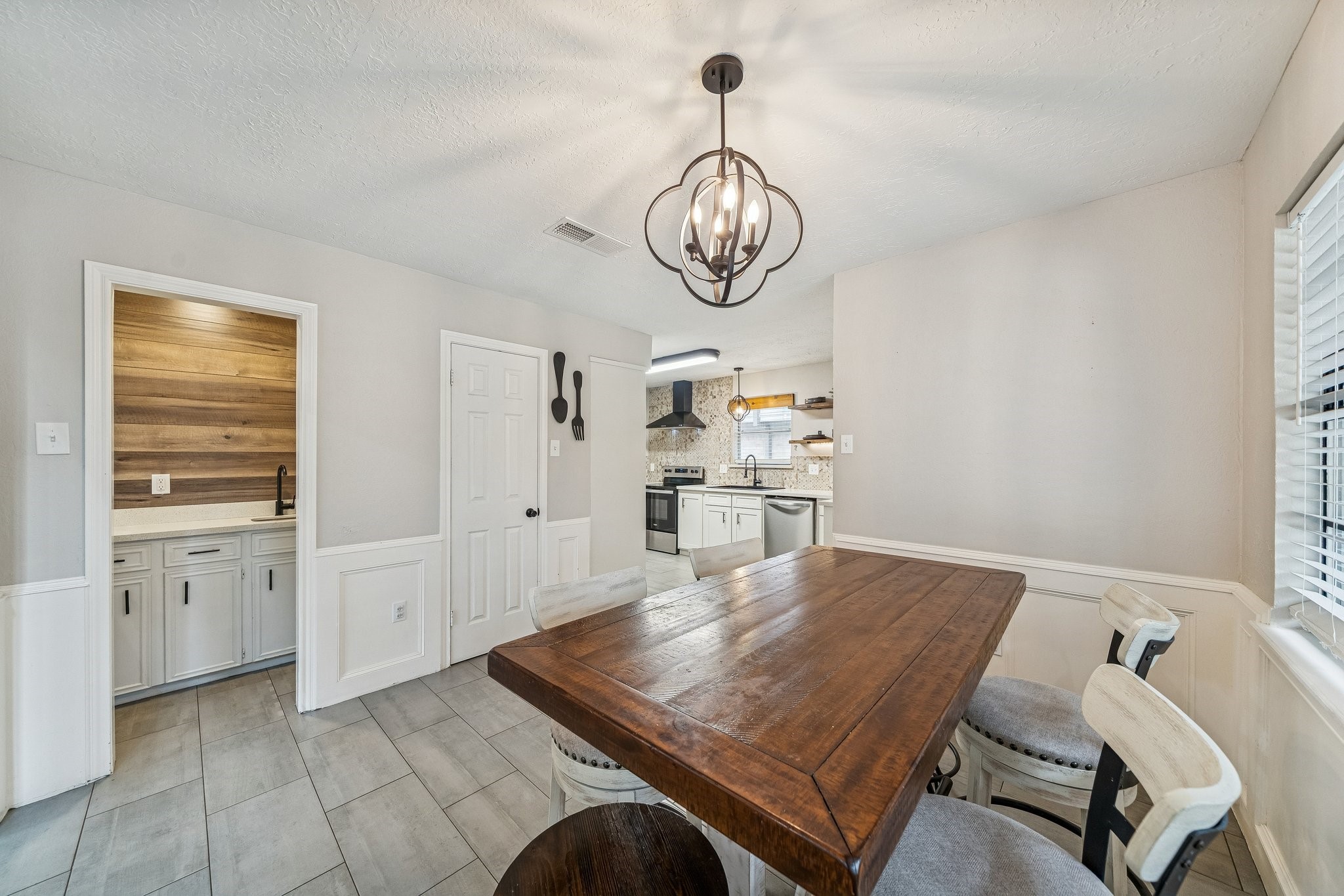 3315 Candleridge Drive Spring, TX 77388 - Photo 5 of 25 Discover the charm of this inviting dining area featuring a stylish coffee bar with a sink, seamlessly blending convenience with elegance for your daily rituals.