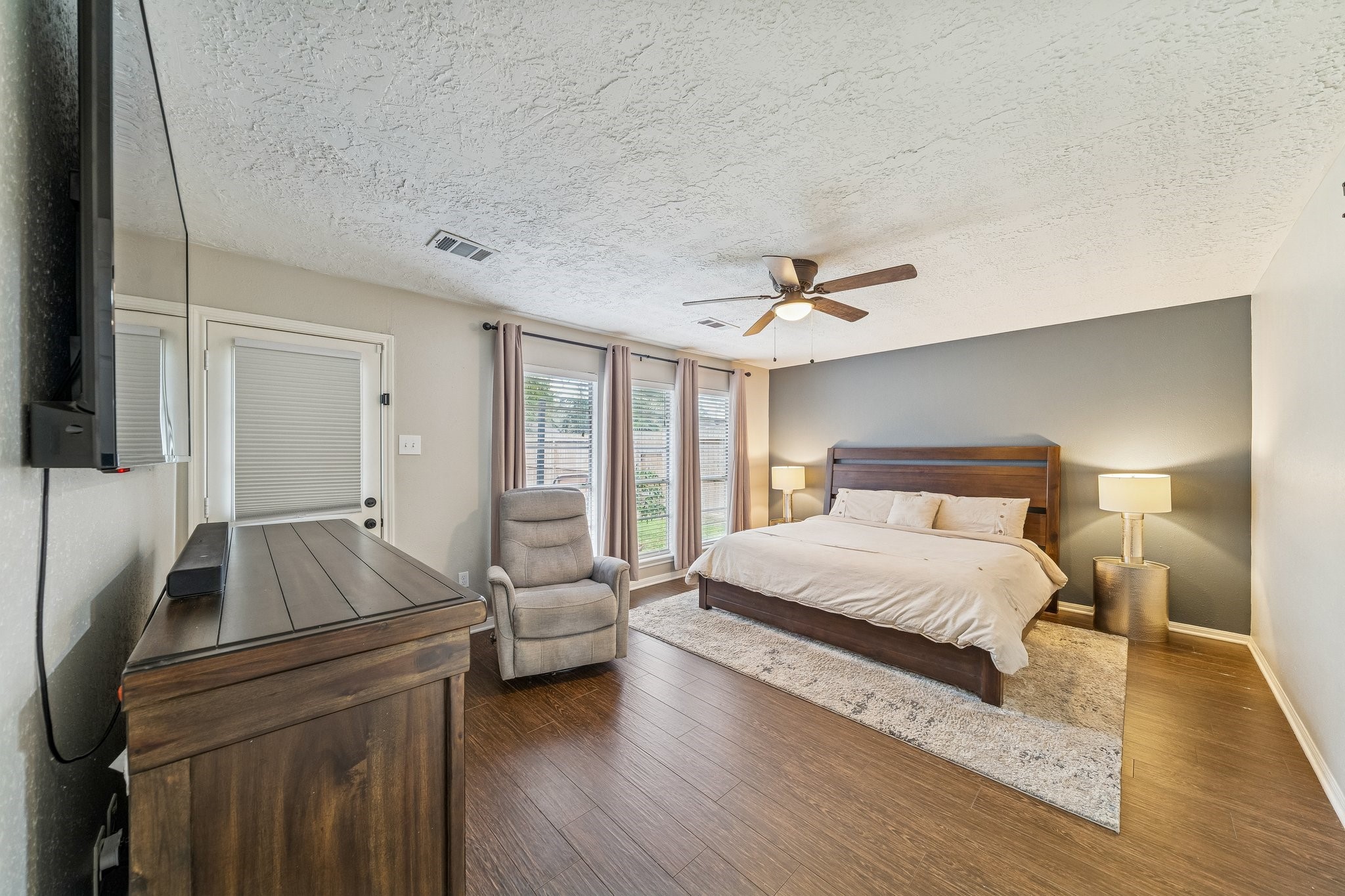 3315 Candleridge Drive Spring, TX 77388 - Photo 7 of 25 Experience luxury and convenience in this primary suite featuring seamless private access to a serene backyard patio, perfect for tranquil morning retreats or evening relaxation.